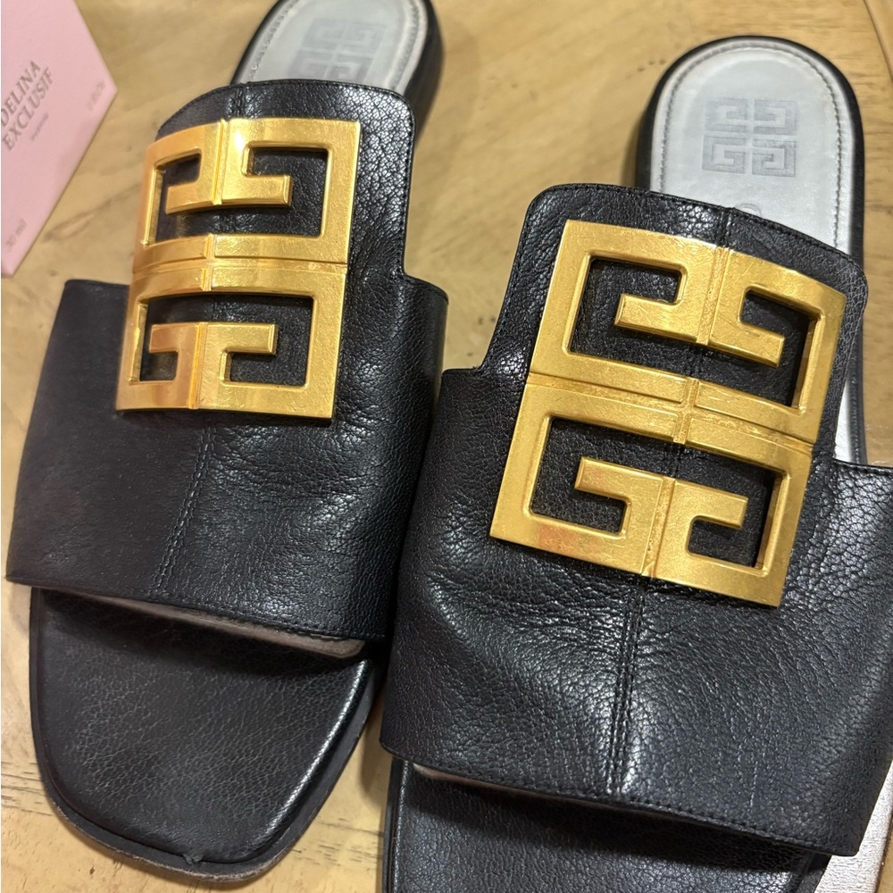 Authentic Givenchy Black and Gold Slide Sandals with Givenchy in front.